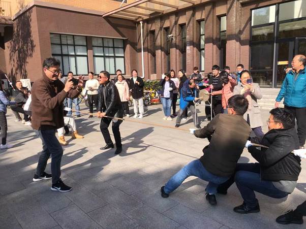 A picture containing building, person, outdoor, people
Description automatically generated